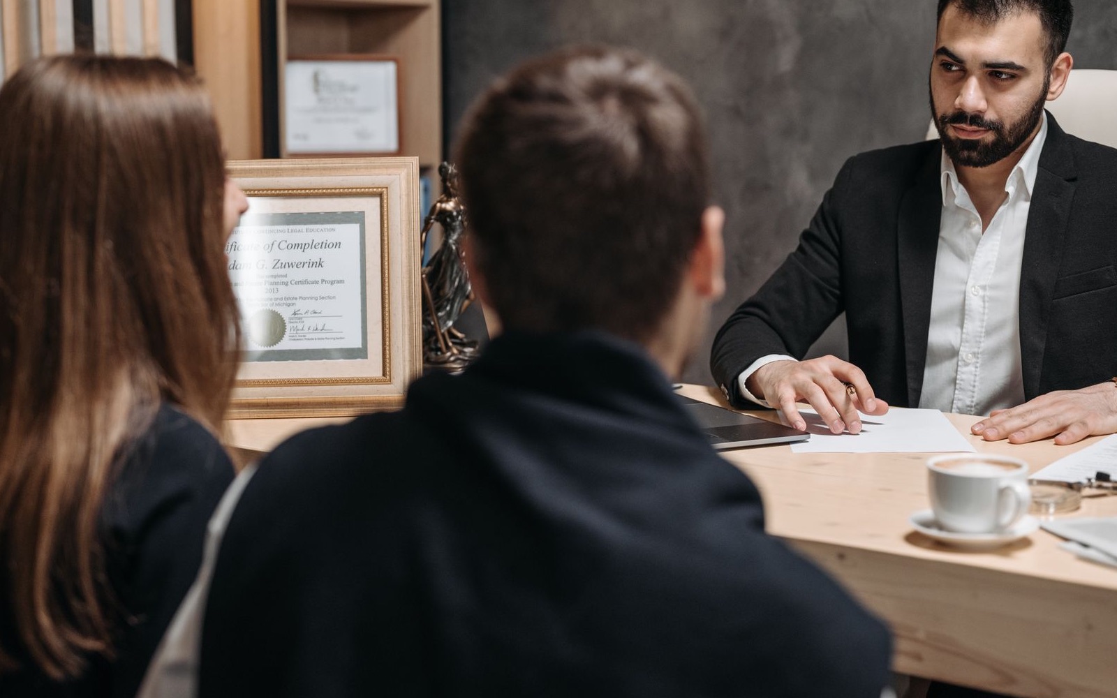 A lawyer meeting clients and reviewing their documents